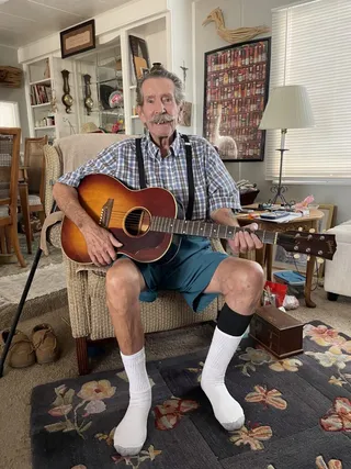 Happy client Lyman playing a 1948 Gibson L-50 acoustic guitar after selling it to Joe