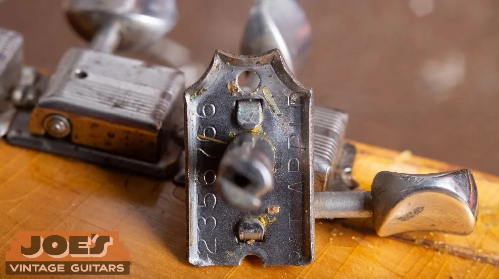 The underside of a vintage Kluson Deluxe tuner casing stamped PAT. APPLD.